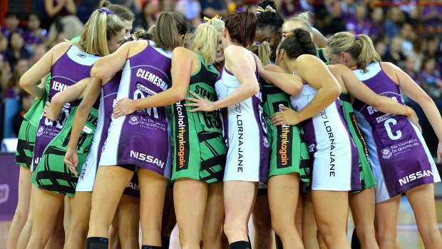 Show of unity: Players from the Firebirds and the Fever embrace before their clash at Brisbane Entertainment Centre.