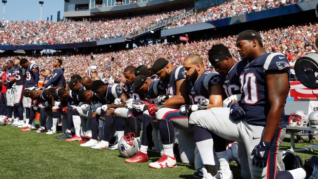 New England Patriots players show their support for the #TakeThe Knee campaign.