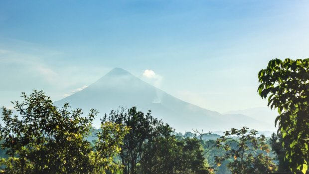 Chicabal volcano rises out of the forest.