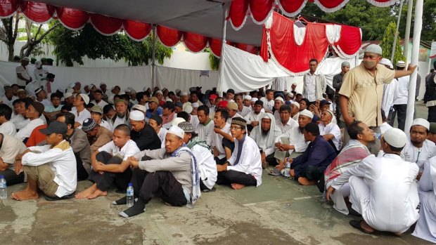 Supporters of radical Indonesian cleric Abu Bakar Bashir wait outside court in Cilacap.