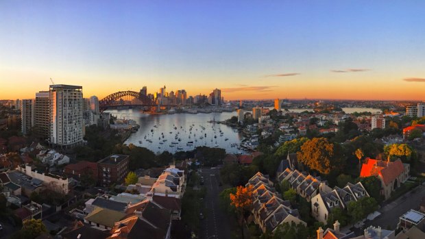 The sun rises over the city as viewed from North Sydney.