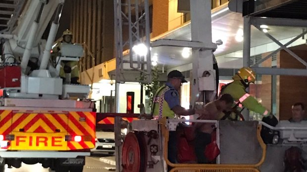 Ready or not, here they come: Police apprehend a teenager allegedly hiding on the second storey of a construction site in Perth. 