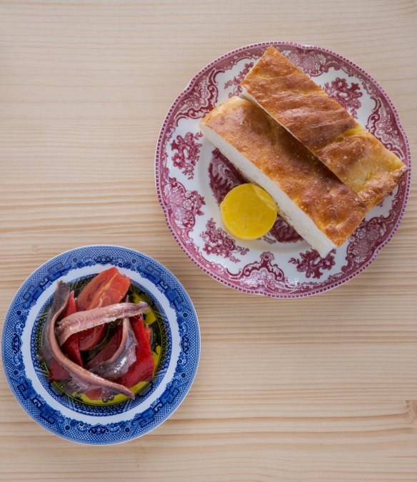 Proud focaccia comes with a selection of condiments such as anchovies and cured tomatoes. 