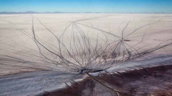 Vehicle tracks scar the Salar de Uyuni. 