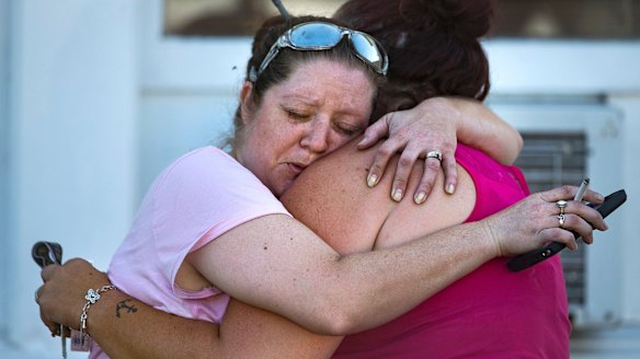 Carrie Matula embraces a woman after a fatal shooting at the First Baptist Church in Sutherland Springs, Texas, on Sunday.