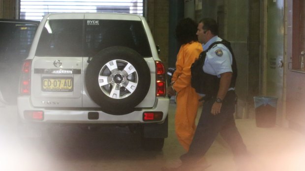 Ahmed Saiyer Naizmand is taken away from Burwood Local Court on March 1