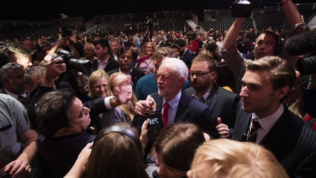 Jeremy Corbyn surrounded by members of the media at an event to announce the results of the Labour leadership contest.