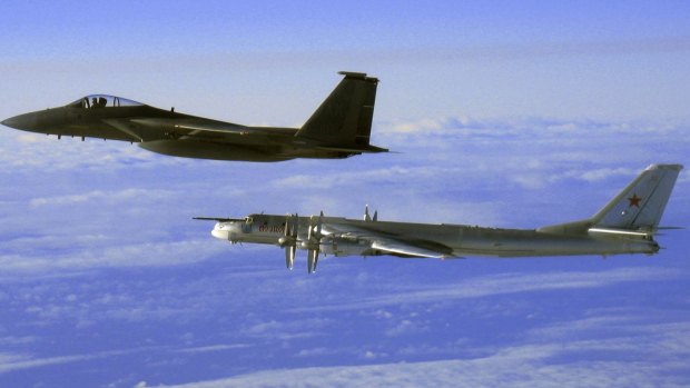 Interception: A US F-15 flying next to a Russian Tu-95 "Bear" bomber, right, during a Russian exercise near Alaska in 2006. 