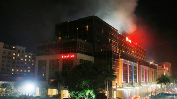 Smoke rises from the Resorts World Manila complex near Manila, Philippines.