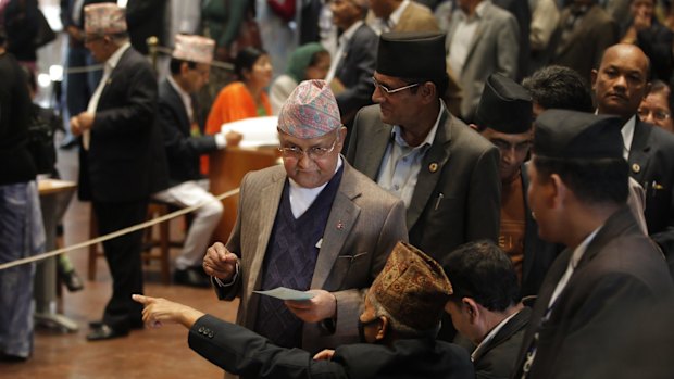 Nepalese Prime Minister Khadga Prasad Oli, centre, prepares to cast his vote as legislators vote for a new president in Kathmandu, Nepal, on Wednesday.