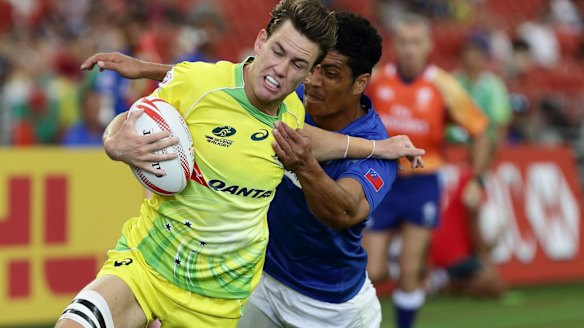 Good day out: Lachie Anderson is dragged back in the Pool game against Samoa.