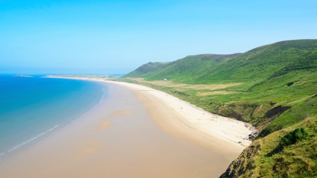 Rhossili Bay Beach, Gower Peninsula, Wales. A beautiful expanse of pristine sand often voted one of the world's best beaches, and popular for surfing. 