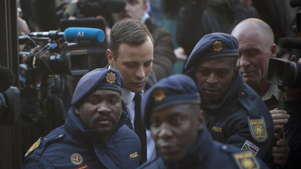 Oscar Pistorius, second from left, arrives at the High Court in Pretoria, South Africa.