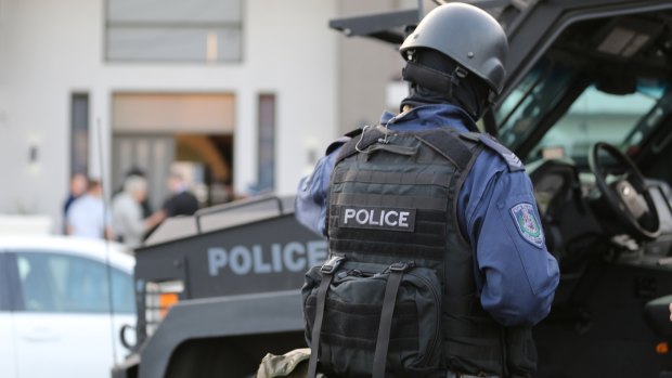 Police conduct a raid in Lockwood Street, Merrylands.