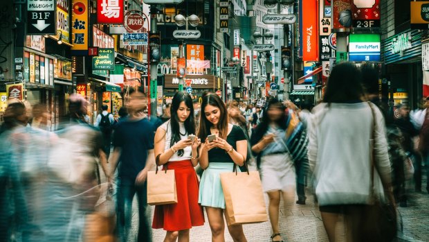 Japanese girls hanging out on Shibuya streets of Tokyo. 