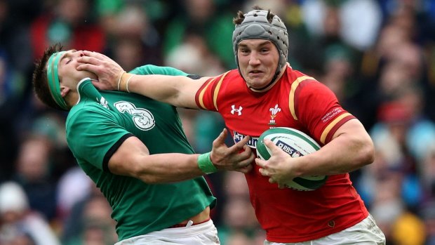 Jonathan Davies buses off CJ Stander during Wales' Six Nations opener against Ireland on Sunday.