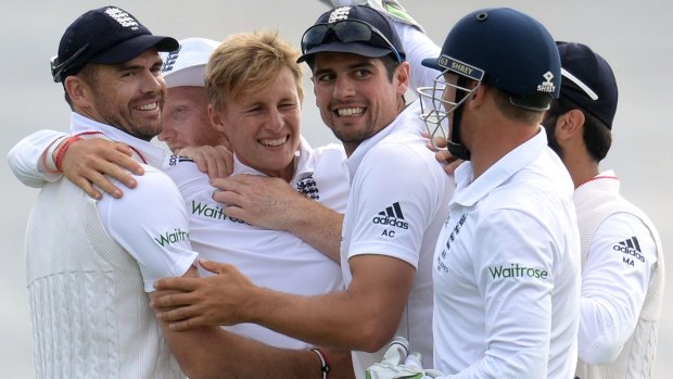 James Anderson, left, celebrates along with Alastair Cook, third from right, and other teammates after his side took a wicket during the first Test.