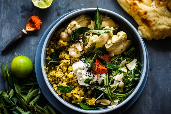 Far from blah: Colourful Sri Lankan curry-poached chicken and rice with salad, condiments and optional naan bread.