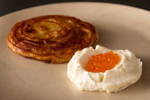 Malawach, a flaky Yemenite pastry, with house-made buttermilk ricotta and trout roe. 