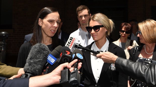 Leanne Adam, (left), the daughter of Keith Cini, along with Kirby Delamont, a victim of one of the home invasions are seen outside the NSW Supreme Court on Friday