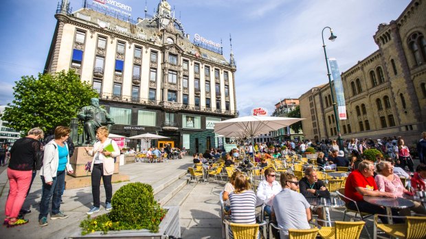 People relaxing in Oslo cafe in city centre, Norway