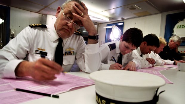 Naval officers on board the HMAS Tobruk filling out a paper census form.