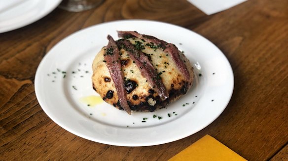 Grilled bread with anchovy at Brat in London.