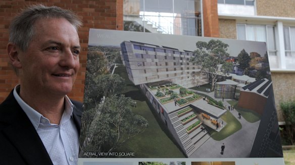 Melbourne architect, John Wardle, principal of John Wardle Architects, outside the Northbourne Flats in 2011 with an illustration of his team's design for the site.