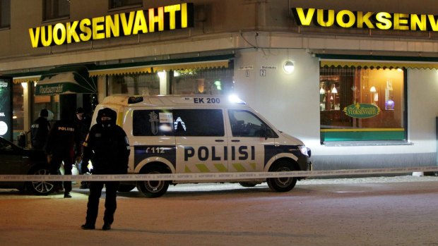 Police guard the area where three people were killed in a shooting outside a restaurant in Imatra, Finland on Sunday morning.