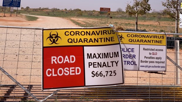 Queensland signage warns of penalties for crossing into the state from NSW at the lonely Cameron Corner border crossing, 1330 kilometres northwest of Sydney.