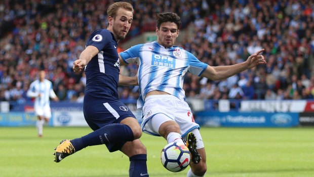 One-sided: Harry Kane and Christopher Schindler battle for the ball at the John Smith's Stadium, Huddersfield.