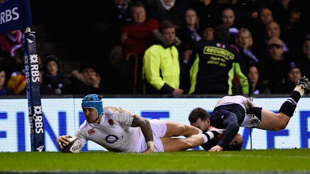 Try time: Jack Nowell dives over despite the tackle from Tommy Seymour to score his team's second try.