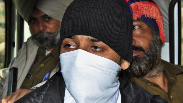 Puneet Puneet, foreground, is escorted by policemen at a district court in Rajpura, in northern India.