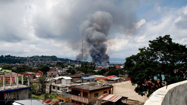 Fire rages at several houses following airstrikes by Philippine Air Force bombers to retake control of Marawi city from Muslim militants