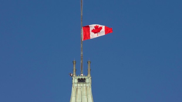 The flag flies at half-mast on the Peace tower in Ottawa. 