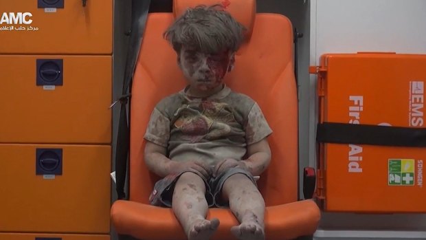 Omran Daqneesh sits in an ambulance after being pulled out of a building hit by an air strike in Aleppo, Syria, on August 17.