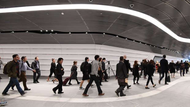 Commuters file through the new tunnel for the first time on Tuesday.