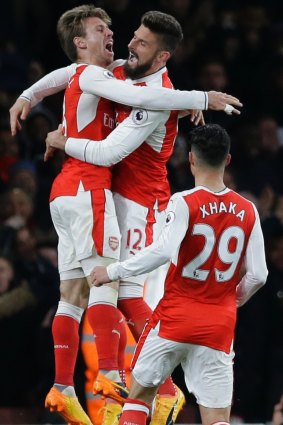 Arsenal celebrate a fortuitous goal against Leicester.