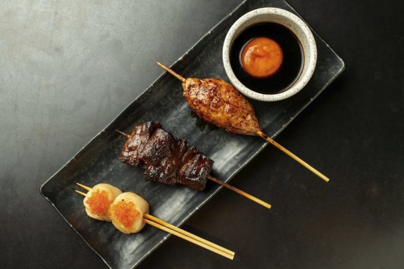 A platter with tsukune (chicken meatball), wagyu and scallop skewers.
