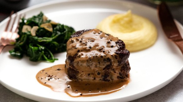 Filet mignon with creamy peppercorn sauce, garlic spinach and Paris mash.