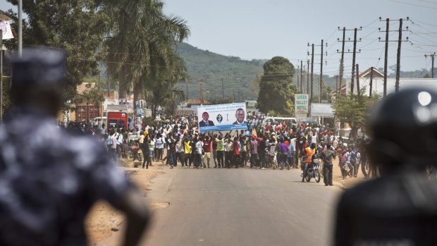 Ugandan riot police confront angry voters in Ggaba, outside a polling station where voting materials for presidential candidates failed to turn up.