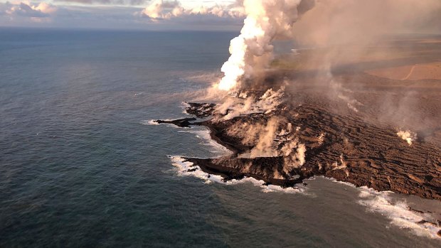Lava from Kilauea Volcano  enters the ocean, with a resulting laze plume, at Kapoho on the island of Hawaii.