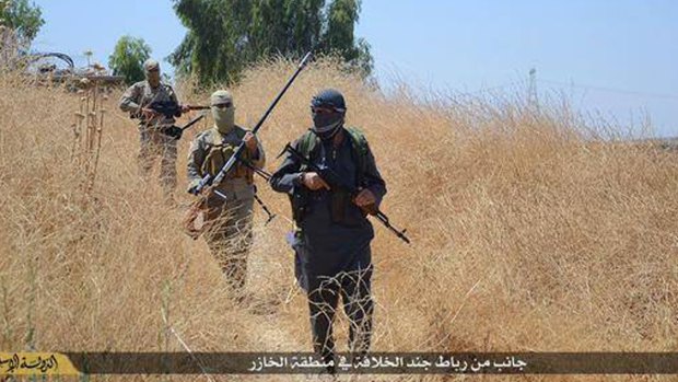Islamic State militants patrol in Khazer, Iraq.
