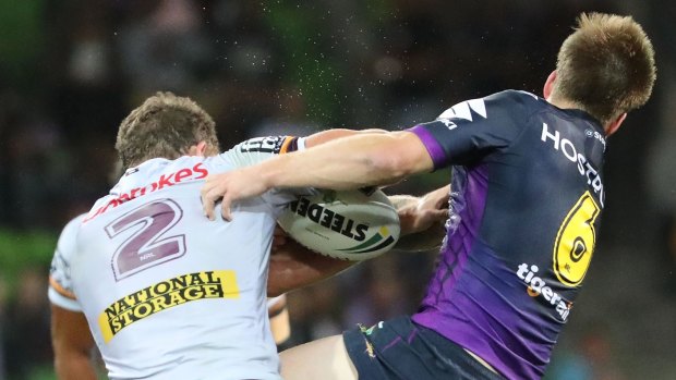 Cameron Munster (right) of the Storm injures his jaw in a tackle on Corey Oates.