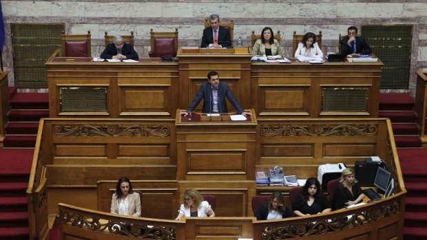 Greek Prime Minister Alexis Tsipras delivers his speech as he attends a parliamentary session in Athens.