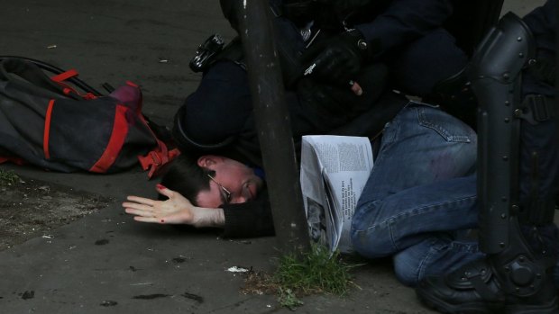 A protester is injured in clashes during an anti-government demonstration in Paris on Thursday.