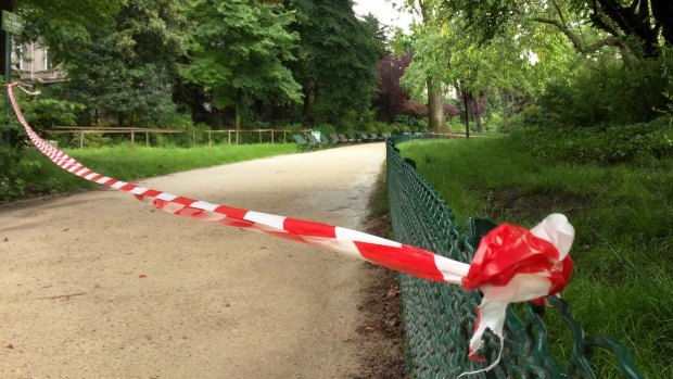 White-and-red tape is strung across a pathway through Parc Monceau after the lightning strike.