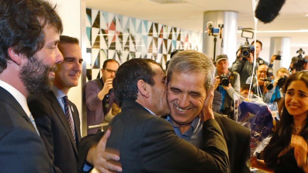 Ali Vayeghan, an Iranian citizen with a valid US visa, kisses his brother Houssein at Los Angeles International Airport.