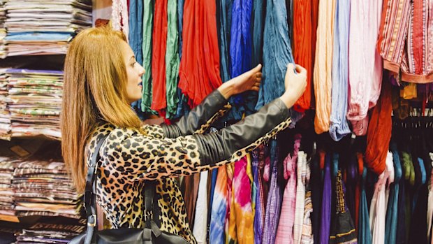 Young Beautiful Woman Shopping Traditional Clothes  istock