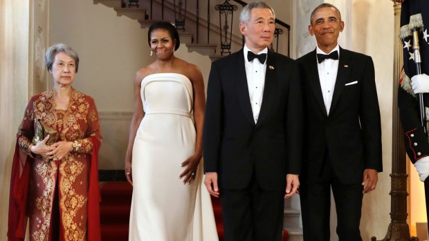 President Barack Obama, right, and Singapore's Prime Minister Lee Hsien Loong, are joined by their wives, Ho Ching, at left, and first lady Michelle Obama, for a photograph at the White House during a state dinner in 2016.
